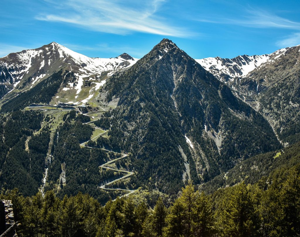 Mountain range with the peak of the mountains covered in snow.