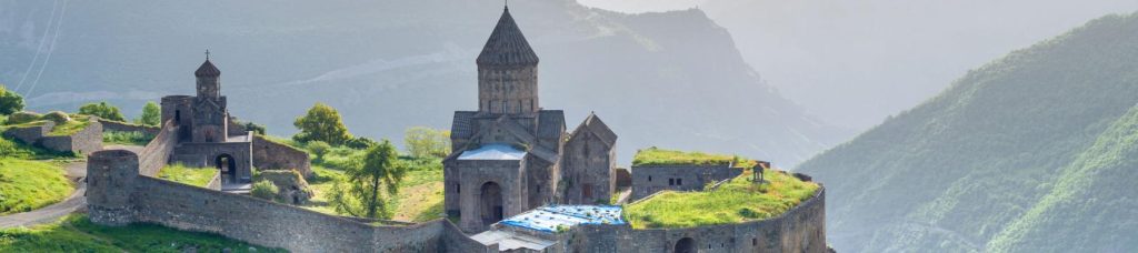 Building in the center of the image surrounded by greenery in Armenia.