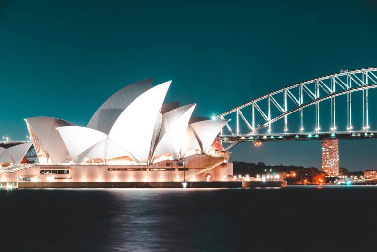 The opera house with Sydney harbor bridge in the background.