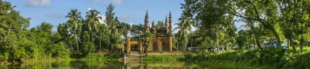 Building in the center of the image surrounded by greenery.