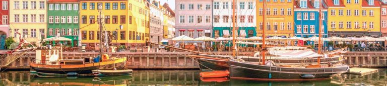 Image of colorful buildings behind a body of water.