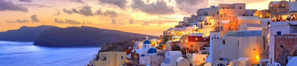 Buildings on a mountain overlooking the ocean of Greece.