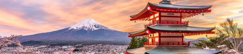 Picture of a red building overlooking a snowy mountain in Japan.