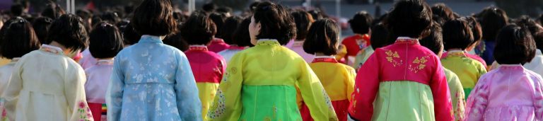 Image of a group of people in colorful traditional outfits.