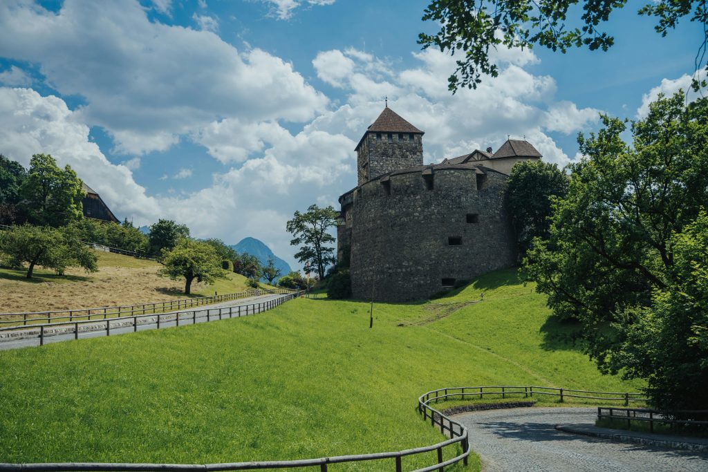 An old building on a big green land in Liechtenstein.